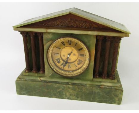 A Victorian green onyx and metal mantel clock case of architectural form, brass dial and chapter ring bearing Roman numerals,