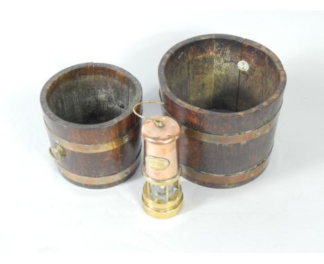 A Hockley Lamp & Limelight Co copper and brass miner's lamp, and a pair of graduated oak and copper bound jardinieres, larges