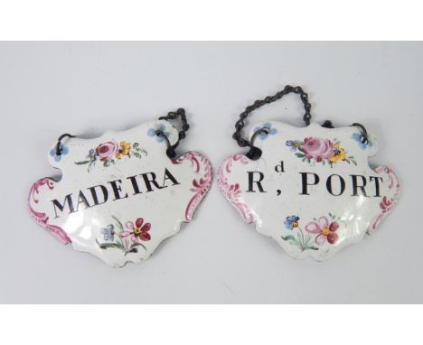 A pair of 19thC Continental enamel decanter labels for Rd Port and Madeira, with floral decoration, 7cm wide.