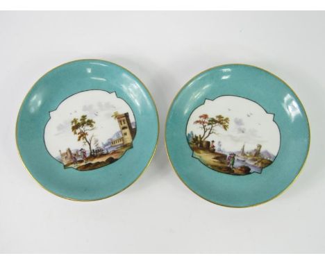 A pair of Meissen style porcelain saucers, painted with Kauffahrtei harbour scenes against a turquoise ground, 13.5cm diamete