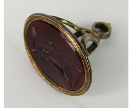 A Regency Cornelian set oval seal intaglio carved with a classical lady, with sword, watering a young plant.