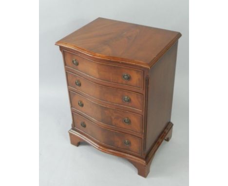 A serpentine mahogany bedside chest, of four long graduated drawers, raised on bracket feet, 52cm x 40.5cm x 71cm.