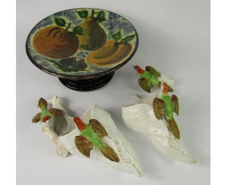 A pair of late 19thC Royal Worcester porcelain wall pockets, moulded with birds, glazed terracotta plate decorated with fruit