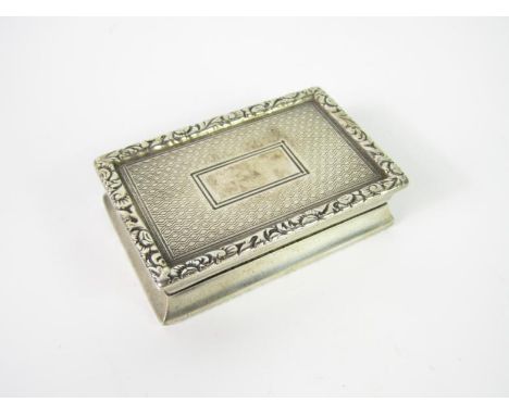 An Edward VII silver vesta case, with engine turned decoration within floral gadrooned borders, Chester 1905.