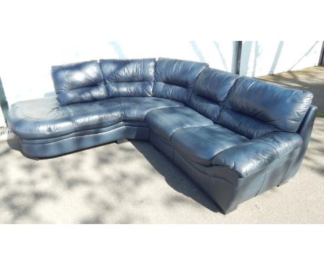 A blue leather six seater curved corner sofa.