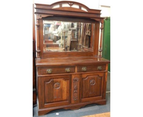 An Art Nouveau mahogany mirror back sideboard, the pierced domed top over a rectangular bevelled glass mirror with turned and
