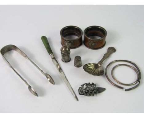 A pair of Victorian sifter sugar tongs, London 1854, caddy spoon, pepperette, thimble and two silver bangles, 4.27oz, pair of