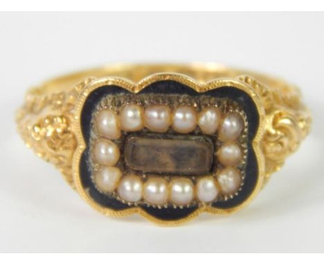 An 18ct gold Victorian memorial ring, the central rectangular memorial panel surrounded by seed pearls, and black enamel, on 