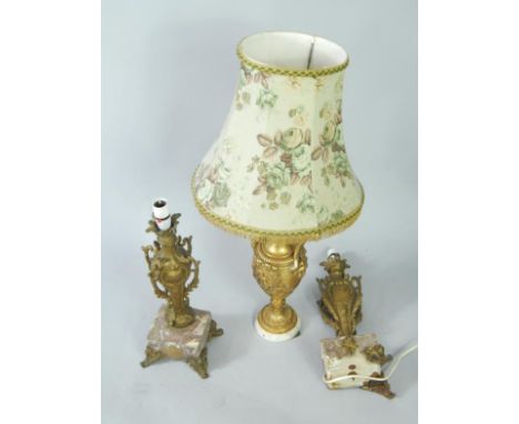 A gilt wood and white marble table lamp, of twin handle baluster form, 75cm high, and a pair of late 19thC rococo style gilt 
