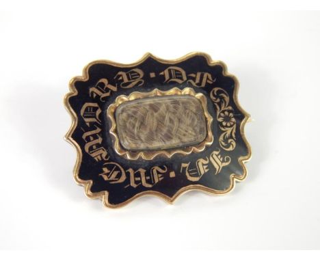 A Victorian memorial brooch, the black enamel design with In Memory Of to front, and hair panel, inscribed to back Cecilia Sa