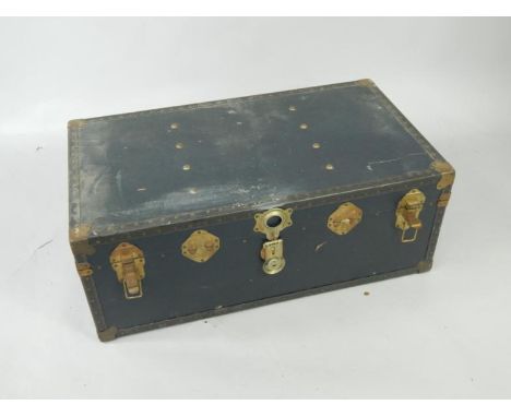 A blue canvas and brass bound trunk, 91cm x 51cm x 35cm.