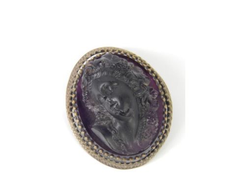 A late 19thC brooch, of intaglio cameo form, of a lady with curled hair, on purple stone, with white metal frame, unmarked, A