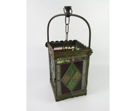 A Victorian brass and stained glass panelled hall lantern, with suspension chain, 17cm x 46cm.