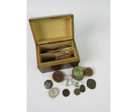 A 19thC crystal seal with an intaglio coat of arms, two glass stamps and wax seal cameos, (qty).
