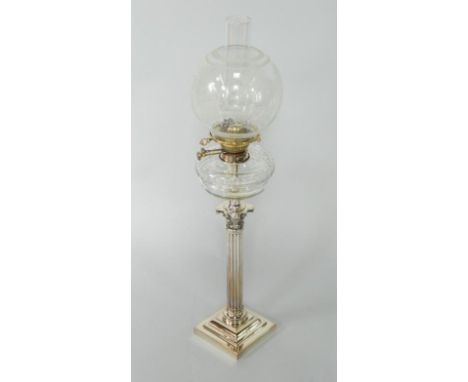 An electroplate Corinthian column oil lamp, with stepped base, cut glass reservoir and etched shade, 74cm high. 