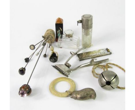 An early 20thC glass scent bottle, in a Bakelite obelisk case moulded with a Geisha girl, plated cat baby's rattle and teethi