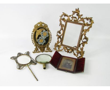 A Continental late 19thC brass and enamel hand mirror, foliate brass strut frame, 27.5cm x 19.5cm, further frame, and a dague