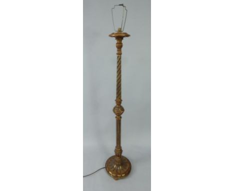 A Victorian giltwood and ebonised standard lamp, of fluted and turned form, raised on a circular base and three bun feet, 167