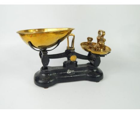 A set of Librasco cast iron and brass scales, Libra Scale Co, with five brass weights.