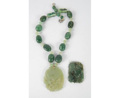 A Chinese jade carving of peaches, 5cm x 3.5cm, and a jade pendant necklace carved with a phoenix, 5.5cm x 4.5cm.
