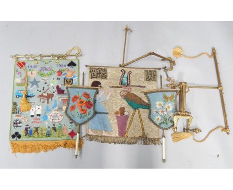 A wool and beadwork Egyptianesque banner on a brass clamp frame, further woolwork banner, pair of wool and beadwork tapestry 