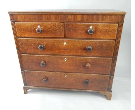 A Georgian oak and mahogany chest of drawers, with two short and three long drawers, raised on bracket feet, 119.5cm x 52.5cm