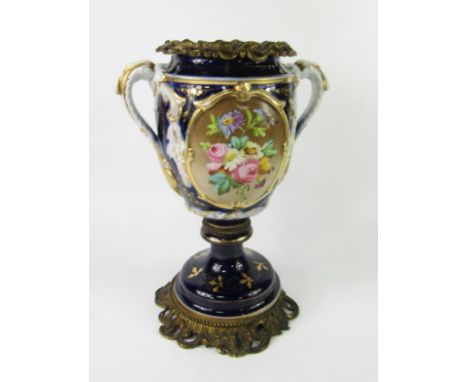 A French late 19thC porcelain and brass oil lamp base, of twin handled baluster form, decorated with a floral reserve against