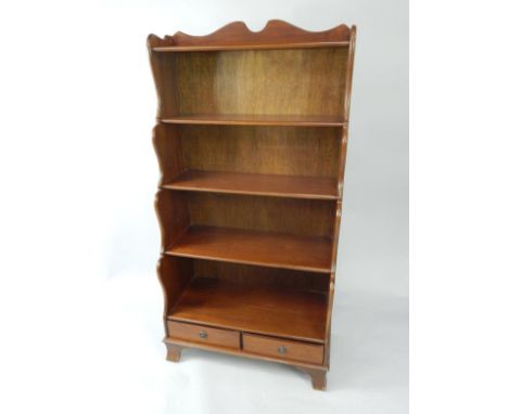 A mahogany waterfall bookcase, of five shelves with two frieze drawers, raised on bracket feet, 76cm x 38cm x 152cm.