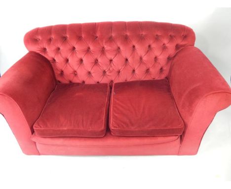 A two seater drop arm sofa, upholstered in red button back draylon, 157cm long.