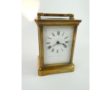 A Duverdry & Bloquel brass cased carriage clock, white enamel dial bearing Roman numerals, 8cm x 6cm x 11cm.