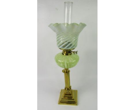 A Victorian brass oil lamp, with green glass reservoir, Hinks duplex burner and a lemon and Vaseline glass shade, 72cm high.