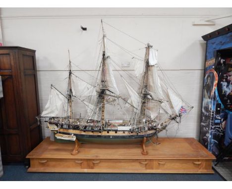 A large scale model of four masted ship, fully ridged and with figures, etc., with remote control, etc., on an adapted light 