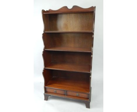 A mahogany waterfall bookcase, of five shelves with two frieze drawers, raised on bracket feet, 76cm x 38cm x 152cm.