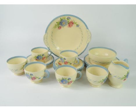 A New Hall early 20thC pottery part tea service, painted with flowers, comprising bread plate, cream jug, sugar bowl, six cup