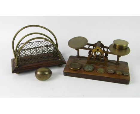 A set of brass postal scales, on a walnut base, with brass weights, and a Murton & Co brass and oak twin division letter rack