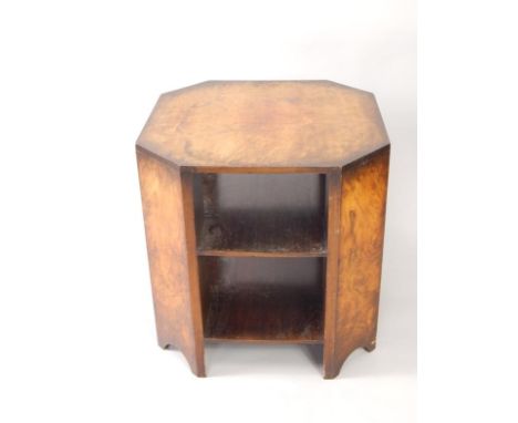 An Art Deco walnut octagonal two tier bookcase, raised on bracket feet, for Army & Navy stores, bears label dated 1935, 60cm 