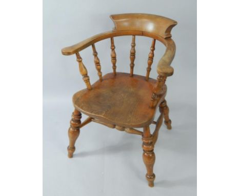An oak and elm captain's chair, stamped G R.