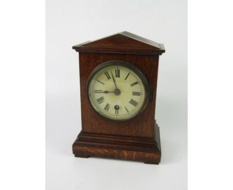 A Victorian oak cased mantel clock of architectural form, enamel dial bearing Roman numerals, thirty hour movement, 16.5cm x 