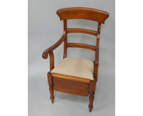 A Victorian mahogany commode carver chair, with drop-in seat, raised on baluster turned legs.