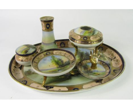 A Noritake porcelain early 20thC dressing table set, painted with riverscapes against a cobalt blue and turquoise ground, gil