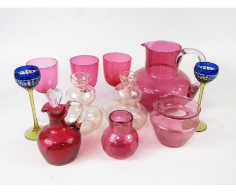 A group of cranberry glass, a pair of blue flashed liqueur glasses with faceted amber stems, and a pair of glass double gourd