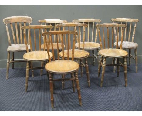 A set of four 19th century pine kitchen dining chairs with stick backs and circular seats, together with three similar and an