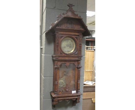 A late 19th century oak cased 8 day wall clock