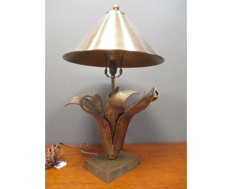 A contemporary brass effect lamp stylised as an exotic plant with matching shade