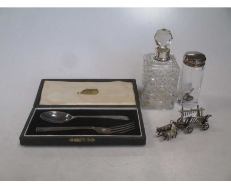 A Silver christening spoon and fork, cased. A Silver topped small glass jar. A South American 800 standard silver bullock and