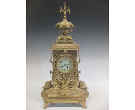 A large brass mantle clock, the white enamelled dial with Arabic numerals, 72cm high