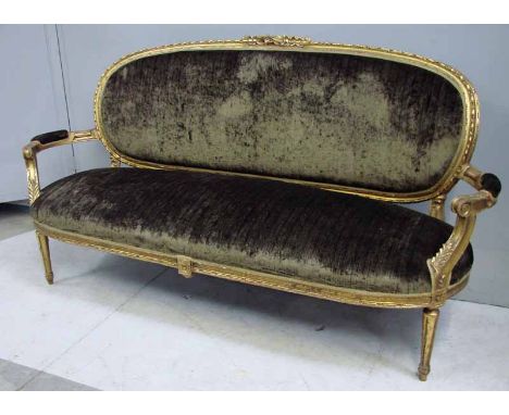 A French Louis XV style dark green upholstered Three Seat Sofa, gilt open arm show frame with central moulded crest over oval