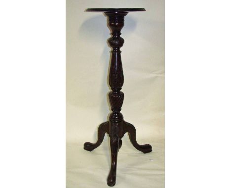 A George III style carved circular Torchere the beaded dish top raised on a turned four section support carved with acanthus 