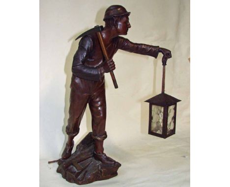 A 19th century French bronze patinated spelter figural Table Lamp as a miner holding a lamp and pick axe, standing full lengt