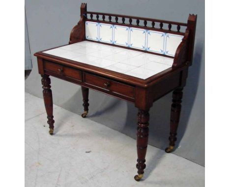 A Victorian mahogany Washstand, the tiled low back with urnular decorated gallery and shaped sides, a moulded rectangular top